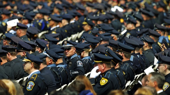 Police officers take their seats for the memorial service for Massachusetts Institute of Technology (MIT) police officer Sean Collier.