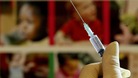 A nurse handles a syringe at a medical centre in Ashford, Kent