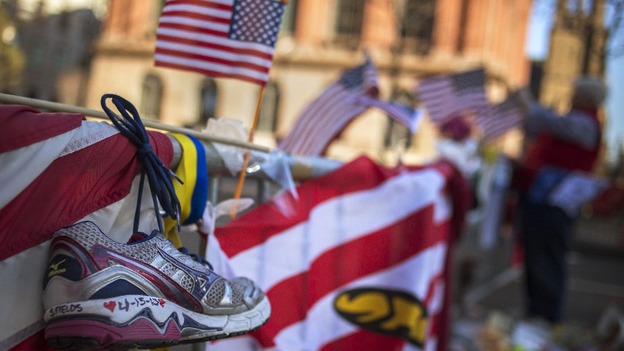 A trainer is seen at a makeshift memorial in Boston