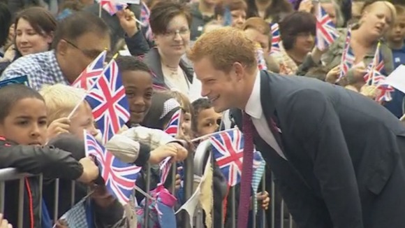 Prince Harry shares a joke with children outside the new Headway HQ.