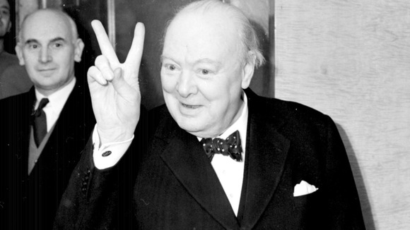 Mr Winston Churchill gives a 'victory' sign whilst on board the Cunard liner Queen Mary, on which he was sailing to New York.