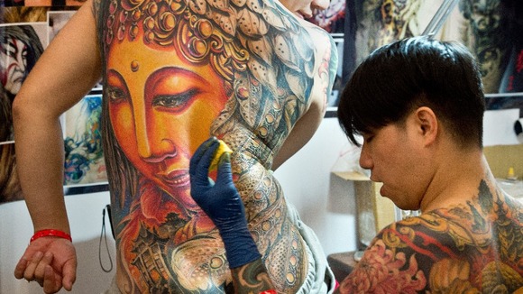 A professional tattoo artist gets to work at the International Tattoo Convention in Germany