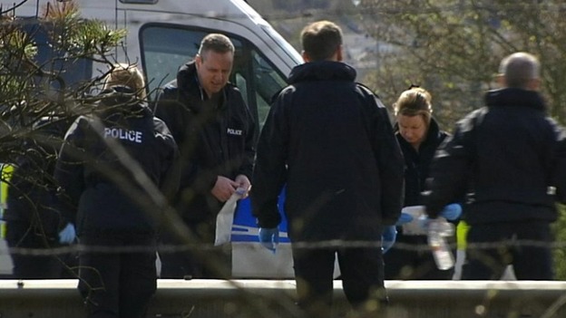 Forensic teams search the carriageway yesterday