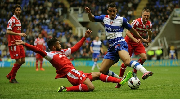 Reading's Nick Blackman (right) is tackled by Queens Park Rangers' Armand Traore.
