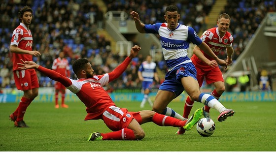 Reading's Nick Blackman (right) is tackled by Queens Park Rangers' Armand Traore.