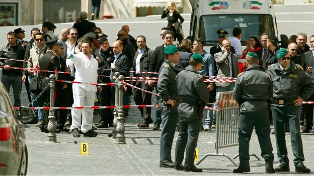 Italian police patrol the area where two officers were shot and wounded outside the Prime Minister's Office.