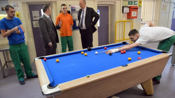 Governor Gary Monaghan (second left) and Justice Secretary Chris Grayling (second right) speak with inmates