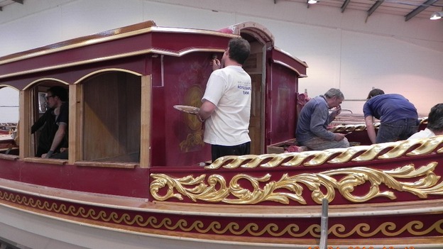Craftsmen work on the boat.