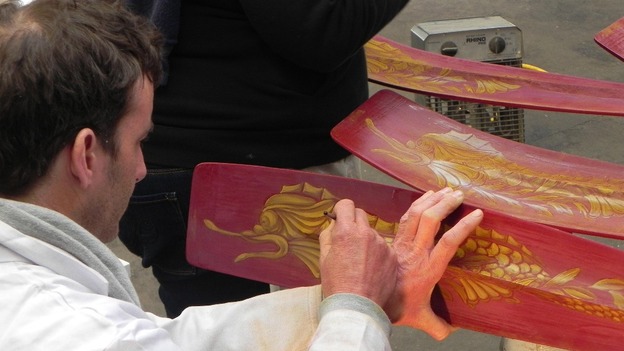 Patterns are painted onto the oars.