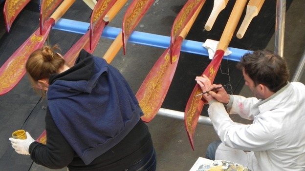 Patterns are painted onto the oars.