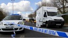 Forensic police officers examine evidence at the crime scene where two men escaped from a prison van that came under attack in Salford