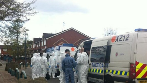 Forensic officers and Tactical Aid Units gather on an estate in Ordsall.