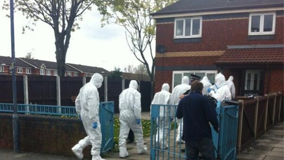 Specialist forensic officers enter the property.