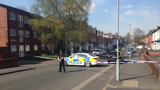 Police officers examine scene.