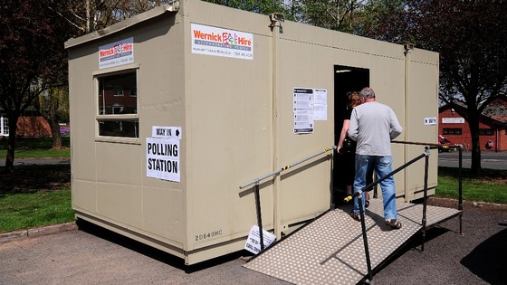 A man walks to a portable polling station in Portia Close, Nuneaton, as voters go to the polls in local elections.