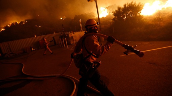 Firefighters battle to protect a CalTrans Maintenance Station and Fuel Depot