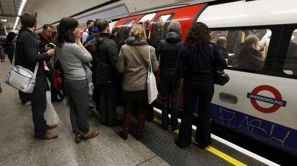 Passengers wait to get on the tube