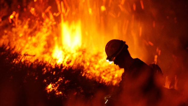 A firefighter with the Silver City Hotshots works to contain the Springs Fire near Newbury Park, California.