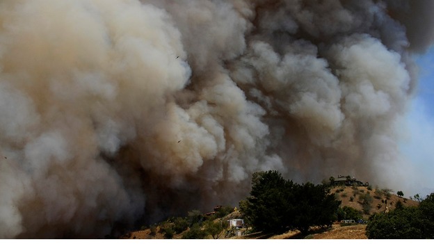 Smoke races through the canyons during the second day of the Springs Fire.