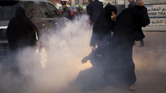 Police use a stun grenade during an anti-government rally in Manama