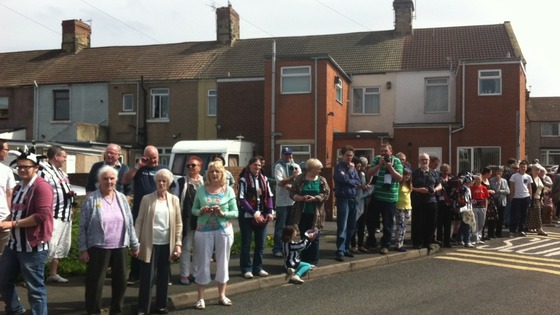 Crowds line the streets to see victory bus parade.