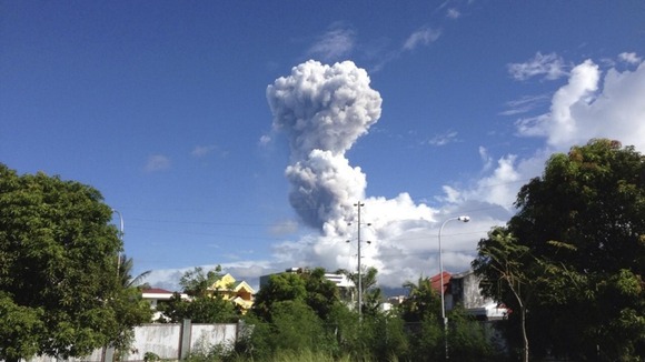 Smoke rises from the volcano as seen from nearby Legazpi city