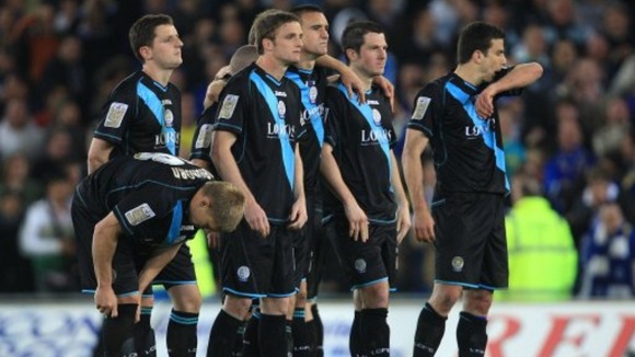 Leicester City players appear dejected after being knocked out of the play offs after the final whistle by Cardiff City