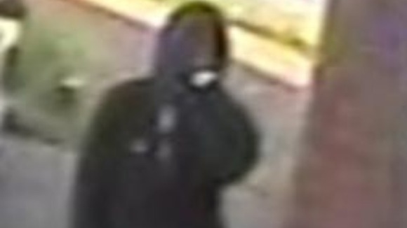 The first man is described as wearing black clothing and a black balaclava