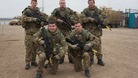 5 soldiers pose with guns