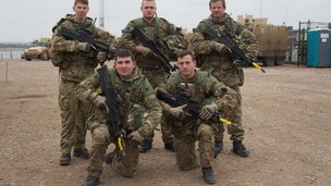 5 soldiers pose with guns