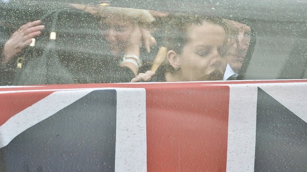 Lyndsey Savage, the wife of Cpl William Savage touches the glass side of the hearse