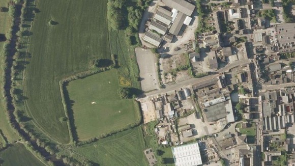 The industrial site is on the edge of Belper close to fields and the Derwent River