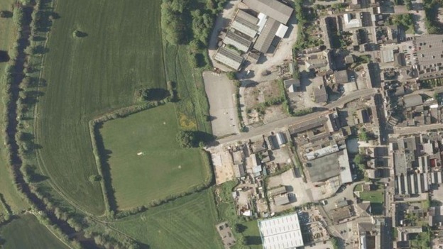 The industrial site is on the edge of Belper close to fields and the Derwent River