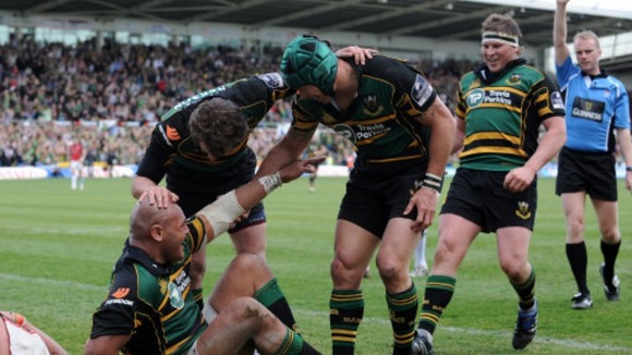 Northampton Saints' Soane Tonga'uiha is congratulated by his team mates after scoring their first try