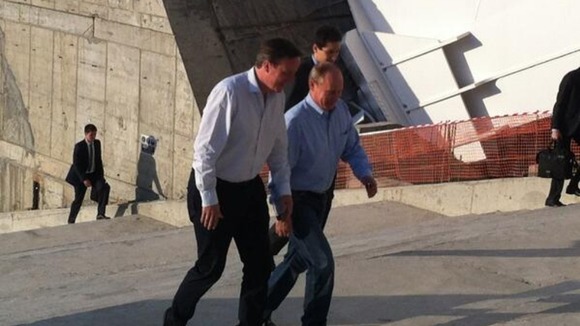 David Cameron (L) tours the Winter Olympic Stadium with Vladimir Putin