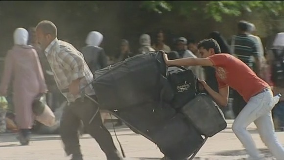 Locals in the Yarmouk district of the Syrian capital Damascus are pacing their bags and leaving.