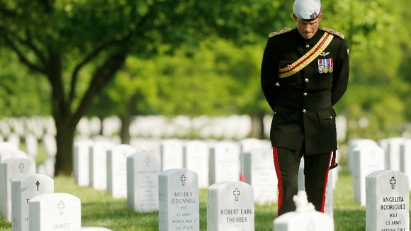 Britain's Prince Harry pauses while visiting Section 60 at Arlington National Cemetery.