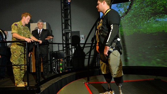 Prince Harry talks to Corey Garmon, 24, who lost both his legs after stepping on a Taliban bomb.
