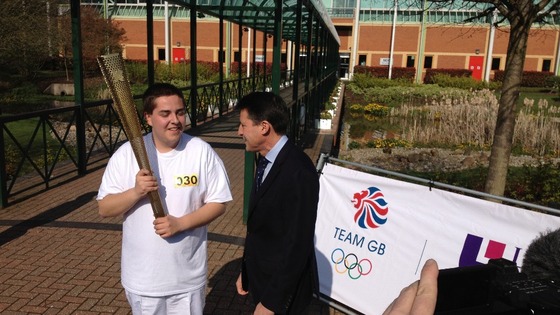 Lord Coe meets one of the torch bearers at Loughborough University. This is Lord Coe's old university.