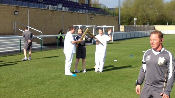 This is called an 'exchange' - the flame is passed over and a new torch bearer takes over the running.
