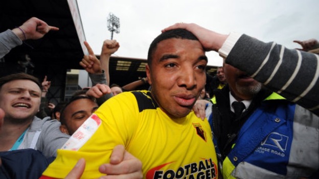 Watford's Troy Deeney is mobbed by fans on the pitch