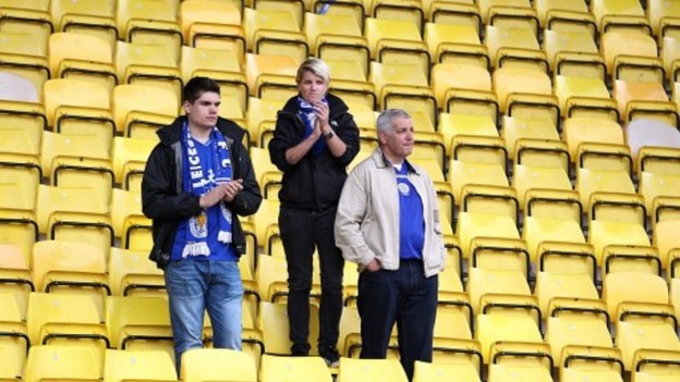 Leicester City fans look dejected in the stands after the final whistle