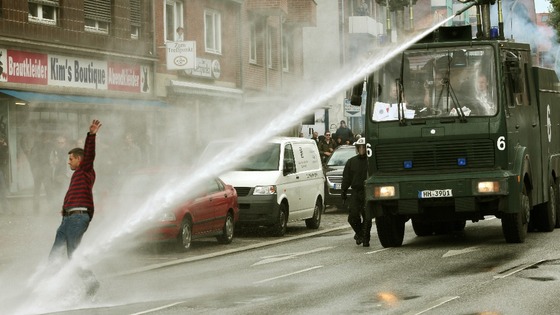 Police with water cannons pushes back people in Germany.