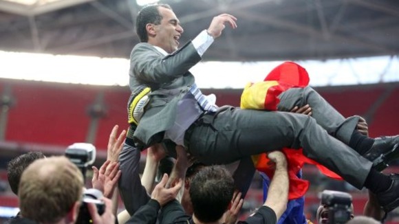 Wigan Athletic manager Roberto Martinez is held aloft by his players following their victory over Manchester City