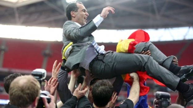 Wigan Athletic manager Roberto Martinez is held aloft by his players following their victory over Manchester City