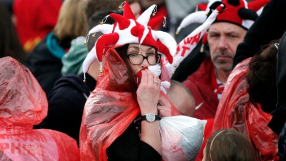 A Manchester United wipes rain from her face as she waits for the Parade to begin 