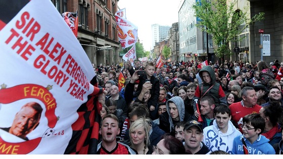 Manchester United fans queue to enter Albert Square