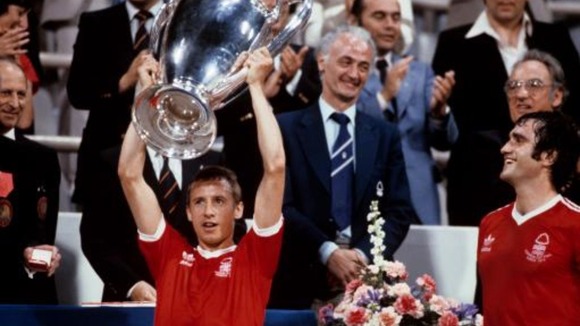 Nottingham Forest's Larry Lloyd (right) looks on as captain John McGovern (left) lifts the European Cup