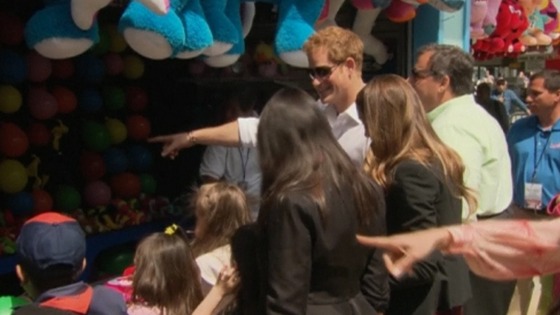 Prince Harry joins children at a fairground attraction