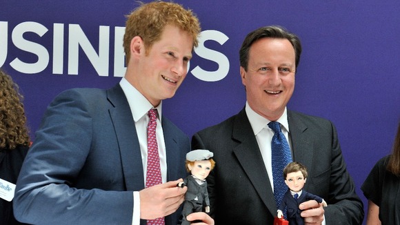 Prince Harry and David Cameron pose with their dolls